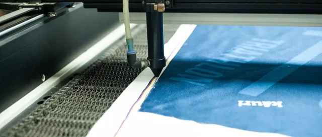 Máquina de corte trabajando sobre el tejido ya sublimado